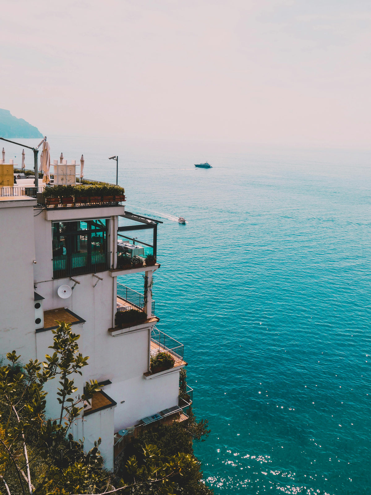 Building with a balcony overlooking the Amalfi coast in Italy.